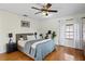 A cozy bedroom featuring hardwood floors, a queen-size bed, and a peloton bike at 126 14Th Ne Ave, St Petersburg, FL 33701