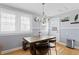 Bright dining area with modern chandelier, wood table, and natural light at 126 14Th Ne Ave, St Petersburg, FL 33701
