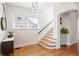 Inviting entryway featuring hardwood floors, staircase, textured walls, and stylish decor and lighting at 126 14Th Ne Ave, St Petersburg, FL 33701