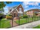Charming brick two-story home with manicured lawn, black metal fence, and inviting front entrance at 126 14Th Ne Ave, St Petersburg, FL 33701