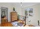 Bright hallway featuring hardwood floors, a wooden dresser, and a cozy sitting chair at 126 14Th Ne Ave, St Petersburg, FL 33701