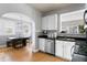 Kitchen features modern stainless steel appliances, white cabinets, and hardwood floors at 126 14Th Ne Ave, St Petersburg, FL 33701