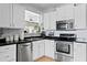 Kitchen featuring stainless steel appliances, white cabinets, and black countertops at 126 14Th Ne Ave, St Petersburg, FL 33701