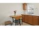 Small kitchenette with a drop leaf table, seating, and wood cabinets at 126 14Th Ne Ave, St Petersburg, FL 33701