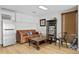 Cozy living room with leather sofa, wood floors, shelving unit, and natural light at 126 14Th Ne Ave, St Petersburg, FL 33701