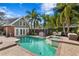 Backyard pool with a spa, outdoor seating, and a detached structure at 126 14Th Ne Ave, St Petersburg, FL 33701