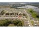 Neighborhood aerial view displaying community layout near lake, showcasing home's location at 13734 Whiskey Daisy Dr, Dade City, FL 33525