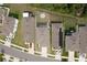 Aerial view showcases the home's layout with a fenced backyard and outdoor seating area at 13734 Whiskey Daisy Dr, Dade City, FL 33525