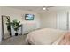 Bright bedroom with a modern dresser, ceiling fan, and large framed mirror enhances the room's appeal at 13734 Whiskey Daisy Dr, Dade City, FL 33525