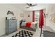 Bedroom featuring a comfortable bed with grey dresser, complemented by a window, modern desk and ceiling fan at 13734 Whiskey Daisy Dr, Dade City, FL 33525