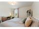 Bedroom featuring a comfortable bed with decorative pillows, complemented by a window and modern desk at 13734 Whiskey Daisy Dr, Dade City, FL 33525