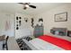 Bedroom featuring a comfortable bed with grey dresser, complemented by a door and ceiling fan at 13734 Whiskey Daisy Dr, Dade City, FL 33525