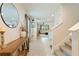 Welcoming entryway featuring tile flooring, a wooden console table, and staircase at 13734 Whiskey Daisy Dr, Dade City, FL 33525