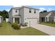 Charming two-story home featuring a two-car garage and well-maintained lawn at 13734 Whiskey Daisy Dr, Dade City, FL 33525