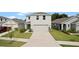 Well-maintained two-story home with a spacious driveway and manicured front yard at 13734 Whiskey Daisy Dr, Dade City, FL 33525
