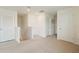 Bright hallway area featuring multiple doors, neutral carpet, and well-lit space at 13734 Whiskey Daisy Dr, Dade City, FL 33525