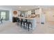 The kitchen has bar seating, stainless appliances, and modern white cabinets at 13734 Whiskey Daisy Dr, Dade City, FL 33525