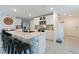 The kitchen has bar seating, stainless appliances, and modern white cabinets at 13734 Whiskey Daisy Dr, Dade City, FL 33525
