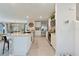 Open kitchen with stainless appliances, bar seating, and modern white cabinets at 13734 Whiskey Daisy Dr, Dade City, FL 33525