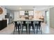 The kitchen has bar seating, stainless appliances, and modern white cabinets at 13734 Whiskey Daisy Dr, Dade City, FL 33525