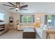 Inviting living area featuring a comfortable white sofa, modern décor, large windows, and a relaxing atmosphere at 13734 Whiskey Daisy Dr, Dade City, FL 33525