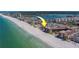 Aerial view of condo buildings and homes on a beautiful beach with clear blue water at 17606 Lee Ave, Redington Shores, FL 33708