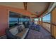 Charming wicker sofa accents a balcony with stunning beachfront views at 17606 Lee Ave, Redington Shores, FL 33708