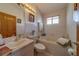 Bathroom featuring a soaking tub, tile surround, vanity, and a window for natural light at 17606 Lee Ave, Redington Shores, FL 33708
