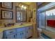 Charming bathroom with a spacious vanity, decorative mirrors, and a bathtub with shower at 17606 Lee Ave, Redington Shores, FL 33708