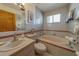 Well-lit bathroom with a soaking tub, tile surround, and stylish fixtures at 17606 Lee Ave, Redington Shores, FL 33708