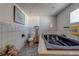 Bright bathroom featuring a jacuzzi tub, toilet, and tiled floors, creating a relaxing and functional space at 17606 Lee Ave, Redington Shores, FL 33708