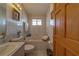 Bright bathroom featuring a soaking tub with tile surround, vanity, and a window for natural light at 17606 Lee Ave, Redington Shores, FL 33708