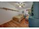 Bedroom with hardwood floors, decorative shelving, and a comfortable bed with accent pillows at 17606 Lee Ave, Redington Shores, FL 33708