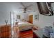 Cozy bedroom featuring hardwood floors, a ceiling fan, and a comfortable bed at 17606 Lee Ave, Redington Shores, FL 33708