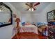 This bedroom has a ceiling fan, a bed and a chair for relaxing at 17606 Lee Ave, Redington Shores, FL 33708
