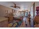 Comfortable bedroom featuring a four-poster bed, ceiling fan, and access to a balcony with ocean views at 17606 Lee Ave, Redington Shores, FL 33708