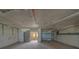 Spacious garage area with roll up door and access to home, perfect for storage or workshop space at 17606 Lee Ave, Redington Shores, FL 33708