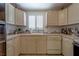 Functional kitchen featuring ample counter space, light-wood cabinets, and white appliances at 17606 Lee Ave, Redington Shores, FL 33708