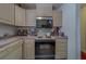 Functional kitchen with ample cabinet storage and vintage appliances at 17606 Lee Ave, Redington Shores, FL 33708