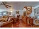 Warm living area with hardwood floors, spiral staircase, and comfortable seating at 17606 Lee Ave, Redington Shores, FL 33708