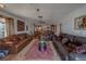 Spacious living room with plush leather sofas, decorative rug, and ample natural light at 17606 Lee Ave, Redington Shores, FL 33708