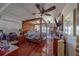 Elegant main bedroom featuring hardwood floors, ceiling fan, dresser with tv, and balcony access at 17606 Lee Ave, Redington Shores, FL 33708