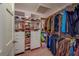 Walk-in closet with custom shelving, drawers, and ample hanging space for clothes and accessories at 17606 Lee Ave, Redington Shores, FL 33708