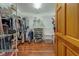 Organized walk-in closet with metal shelving and hardwood floors, providing ample storage space at 17606 Lee Ave, Redington Shores, FL 33708