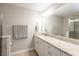 Bathroom featuring granite countertops, a large mirror, and neutral-toned walls at 17847 Althea Blue Pl, Lutz, FL 33558