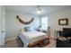 Cozy bedroom with natural light, ceiling fan, and a comfortable sleeping area at 17847 Althea Blue Pl, Lutz, FL 33558