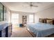 Bright bedroom featuring a ceiling fan, natural light, and stylish decor at 17847 Althea Blue Pl, Lutz, FL 33558