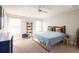 Bright bedroom featuring a ceiling fan, natural light, and stylish decor at 17847 Althea Blue Pl, Lutz, FL 33558