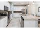 Well-lit kitchen featuring stainless steel appliances, ample cabinetry, and granite countertops at 17847 Althea Blue Pl, Lutz, FL 33558