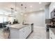Modern kitchen with granite countertops, stainless steel appliances, and connected living area at 17847 Althea Blue Pl, Lutz, FL 33558